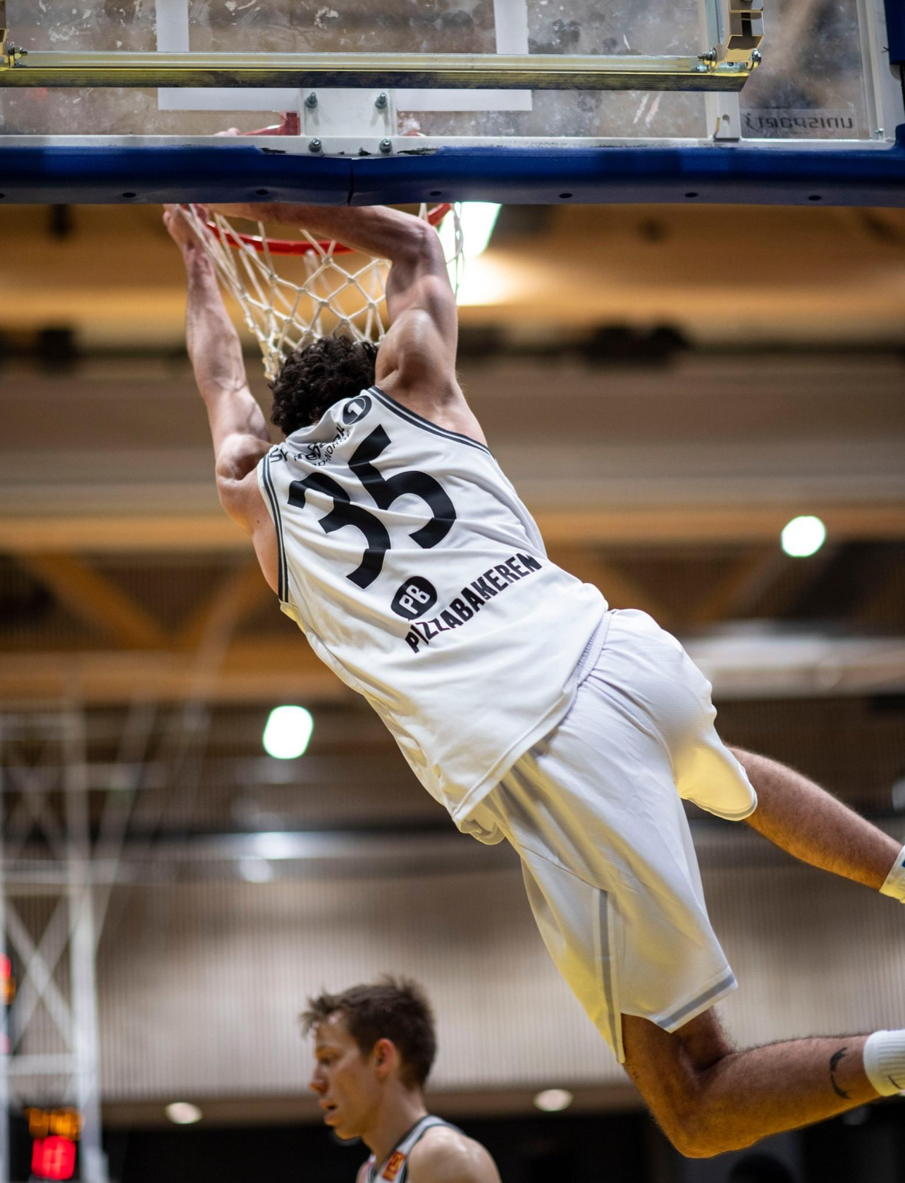 Joey Potts finishing a dunk during his professional basketball career overseas